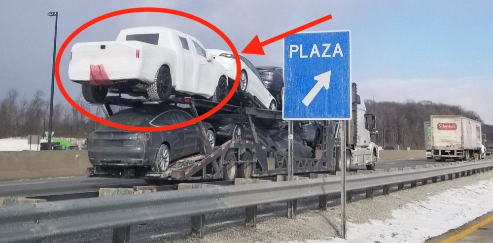 tesla carrier is spotted carrying a wrapped pickup truck sparking speculation