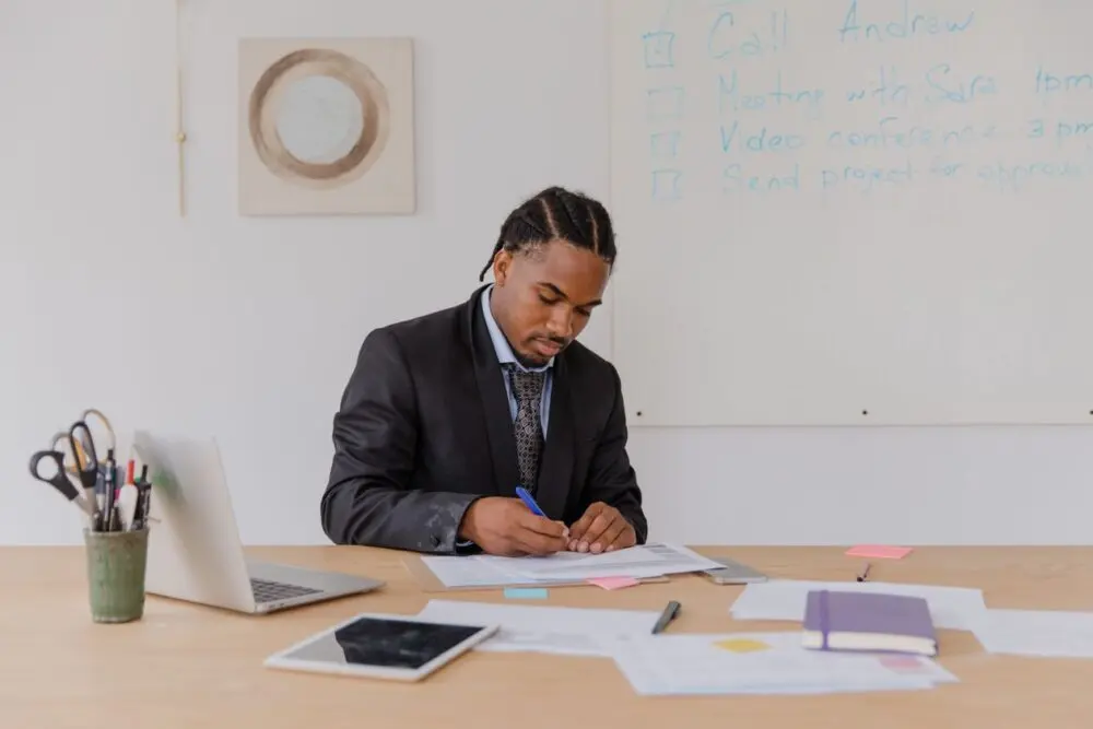 Man signing forms at a desk to start an LLC