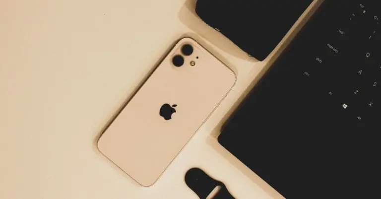 iPhone beside a laptop on a desk ahead of Apple earnings