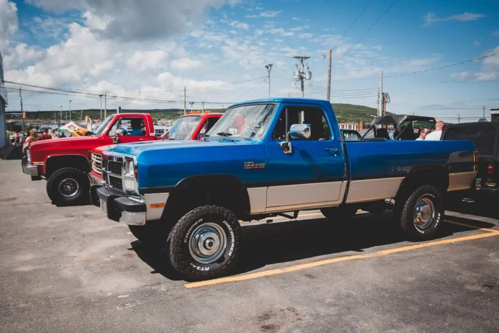Classic blue pickup truck parked at a dealership, a reminder of what GM earnings depend on