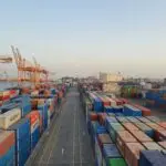 Cargo containers in a harbor, illustrating Canada tariffs and trade
