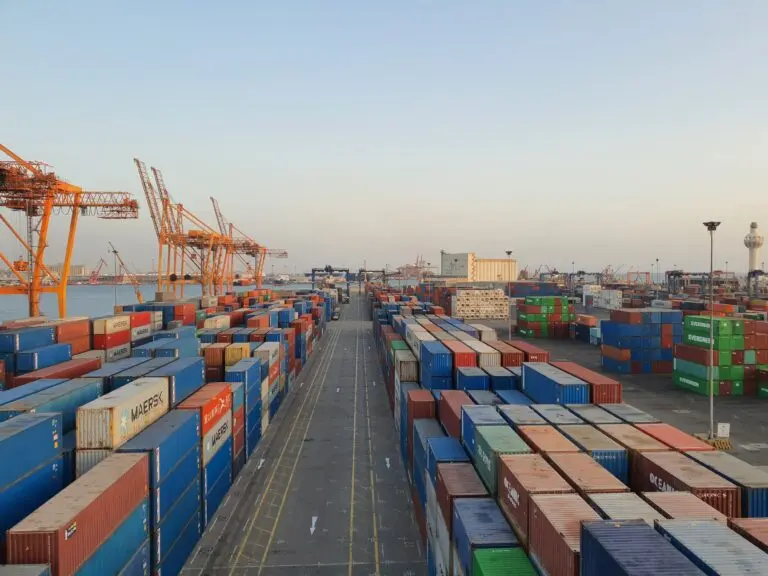 Cargo containers in a harbor, illustrating Canada tariffs and trade