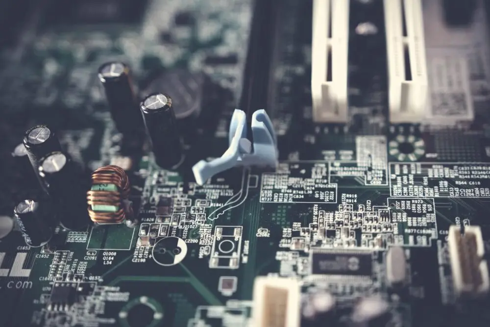 Close-up of a computer motherboard with memory slots and small components