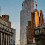 Glass skyscraper reflecting sunset light, a financial district view for Blackstone earnings
