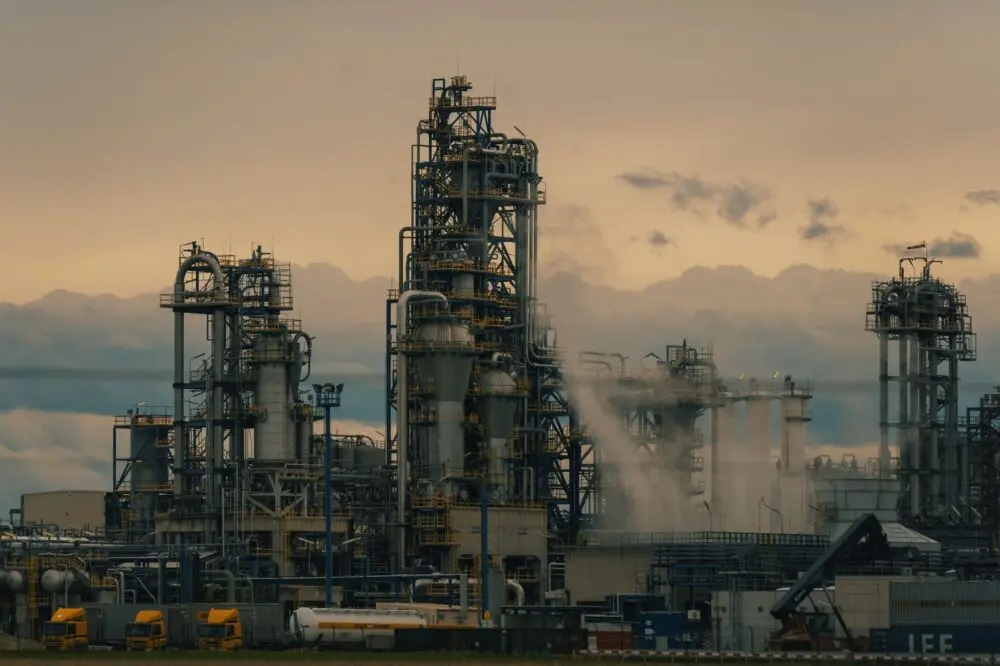 Refinery towers at dusk ahead of Exxon and Chevron earnings