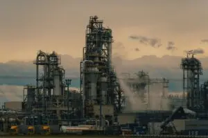 Refinery towers at dusk ahead of Exxon and Chevron earnings
