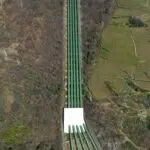 Aerial view of a long gas pipeline running through a forest, a generic picture for the EQT Range merger