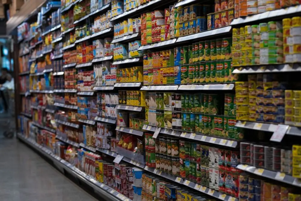 Supermarket aisle with canned goods on shelves