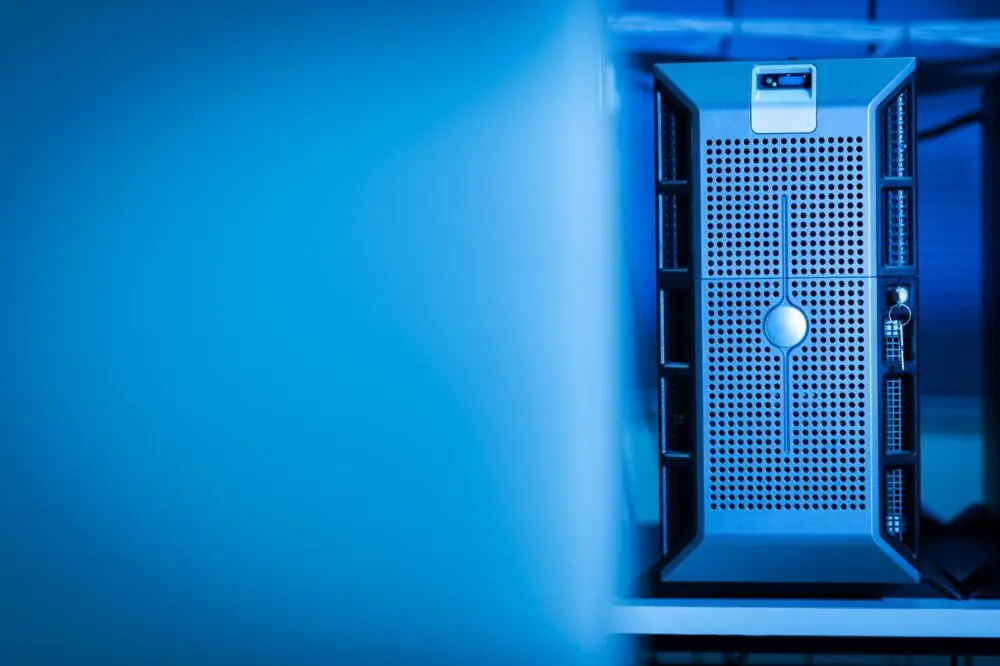 A server unit in a blue lit data center, illustrating the AI spending in focus for Big Tech earnings