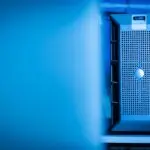 A server unit in a blue lit data center, illustrating the AI spending in focus for Big Tech earnings