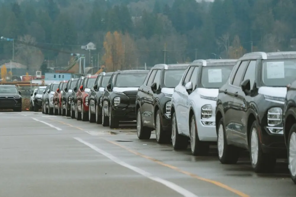 Rows of SUVs in a dealership lot, vehicles dealers may buy after the Copart ACV acquisition