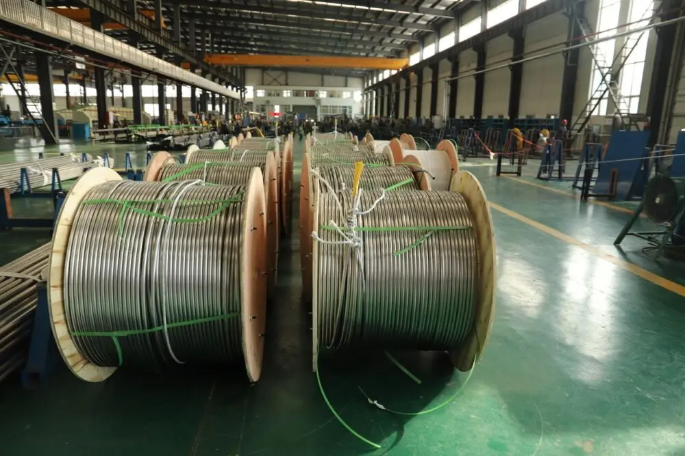 Reels of metal cable in a factory hall, tied to commodity costs in the GM Q3 results