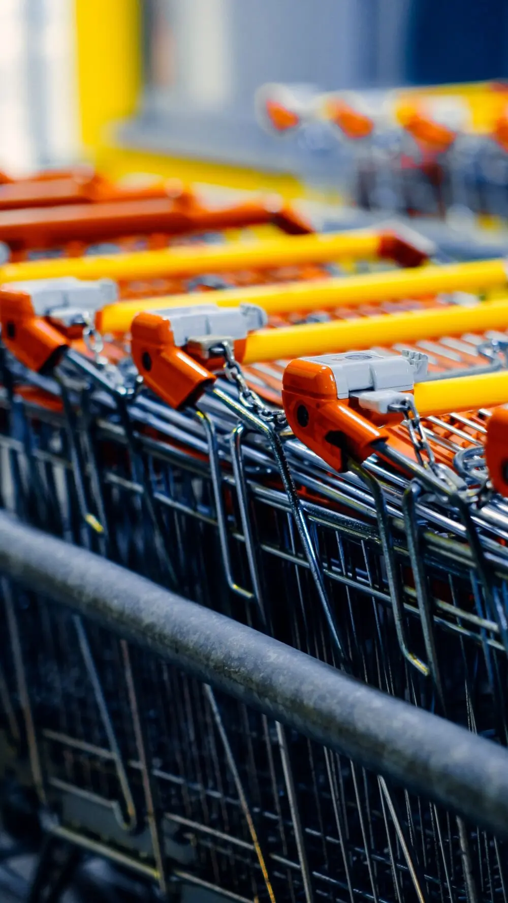 October consumer confidence and spending: orange handled shopping carts lined up in a store aisle