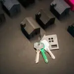 House keys among miniature houses, illustrating the 10 year Treasury yield and mortgage rates