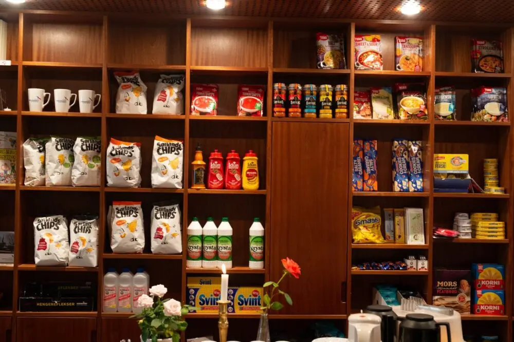 Packaged groceries arranged on wooden shelves in a store