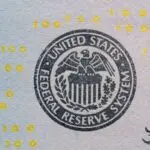 Close up of the Federal Reserve System seal on a U.S. dollar bill, illustrating the FOMC meeting schedule