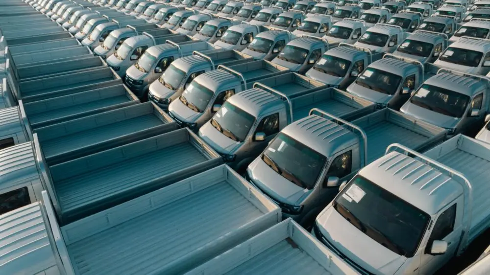 Rows of silver pickup trucks parked in a lot, illustrating the GM Q3 results