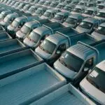 Rows of silver pickup trucks parked in a lot, illustrating the GM Q3 results