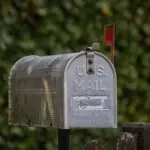 A classic U.S. mailbox with the red flag up, where an FTC refund check might arrive