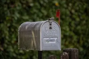 A classic U.S. mailbox with the red flag up, where an FTC refund check might arrive