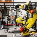 Industrial robotic arm in a factory, the kind of equipment behind the Schneider Electric PTC acquisition