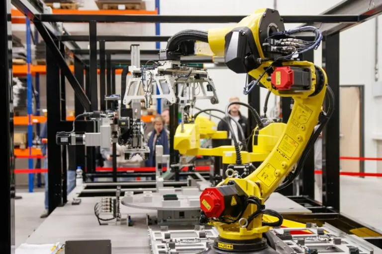 Industrial robotic arm in a factory, the kind of equipment behind the Schneider Electric PTC acquisition