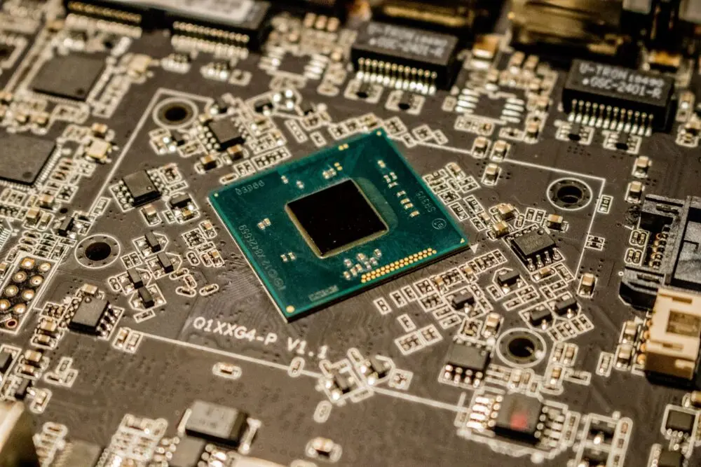Close up of a microchip on a printed circuit board, as used in AI accelerators like Amazon TorchNeuron targets