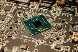 Close up of a microchip on a printed circuit board, as used in AI accelerators like Amazon TorchNeuron targets