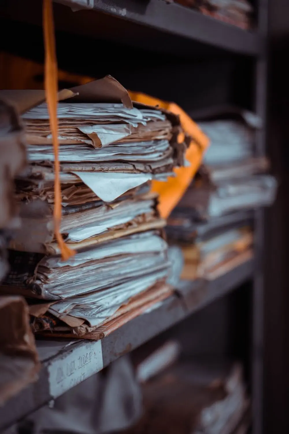 Tall stacks of paper files, a picture of a queue of unfilled withdrawal requests
