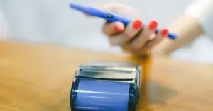 Person paying with a smartphone, as kids can with Google Wallet for Kids