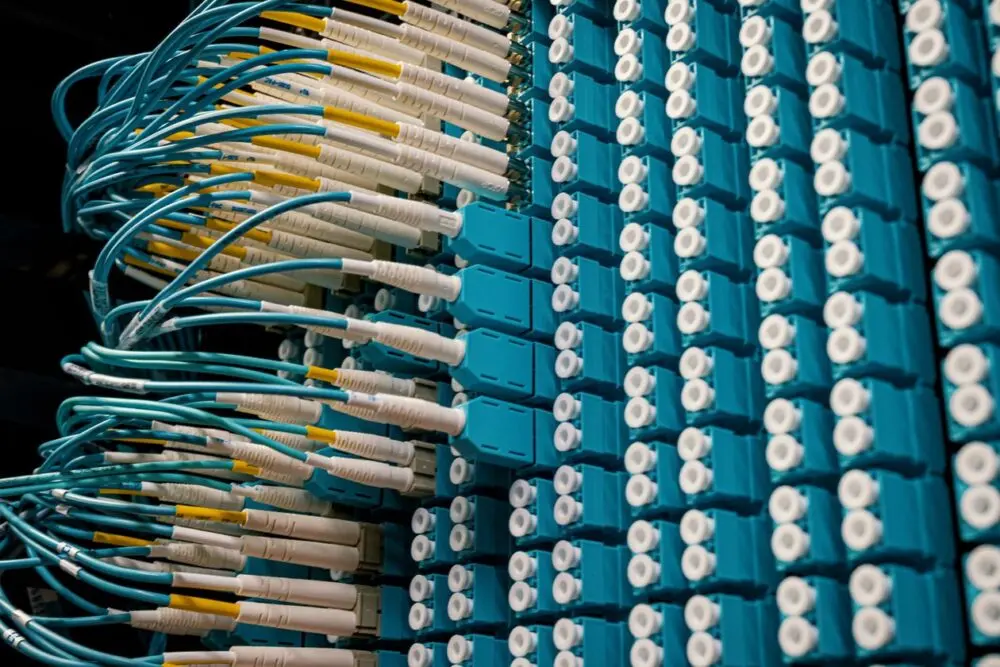 Fiber optic cables plugged into network equipment, the kind of wiring behind Meta Prometheus