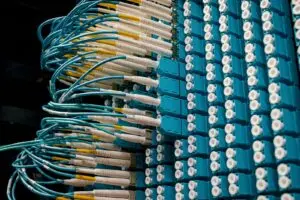 Blue fiber optic patch cables plugged into a data center panel, illustrating the Fortinet earnings story
