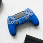 Game controllers near a PS4, ready for a factory reset PS4 guide
