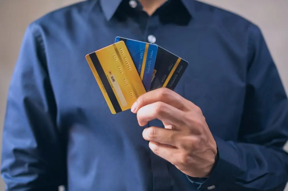 Man holding several credit cards in one hand