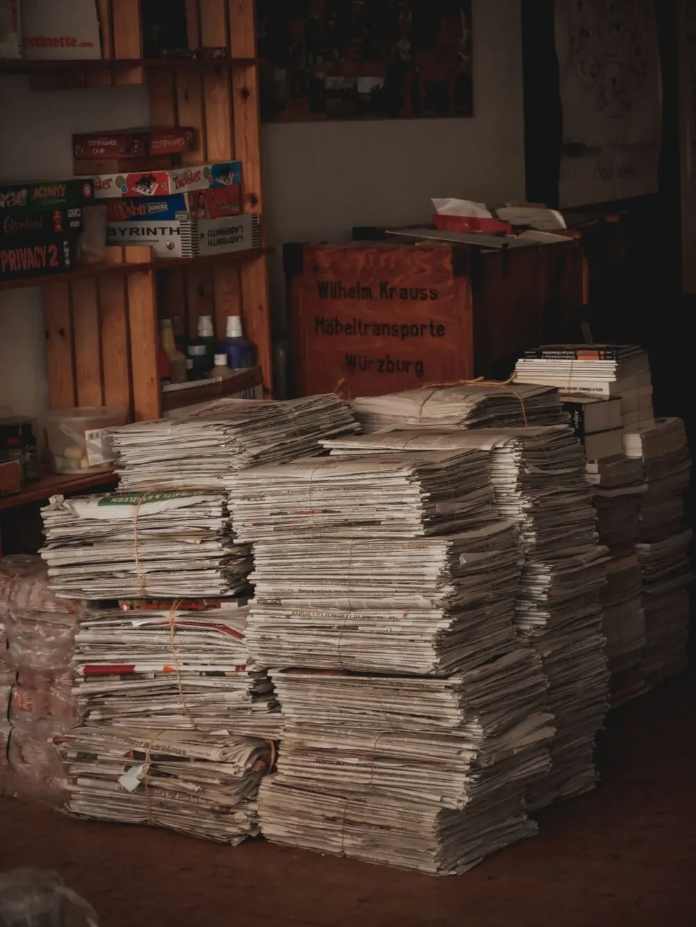 Large stacks of printed newspapers on shelves