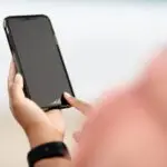 Hands holding a smartphone, tied to the AT&T stock and Starlink Mobile story