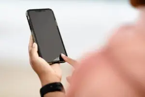 Hands holding a smartphone, tied to the AT&T stock and Starlink Mobile story
