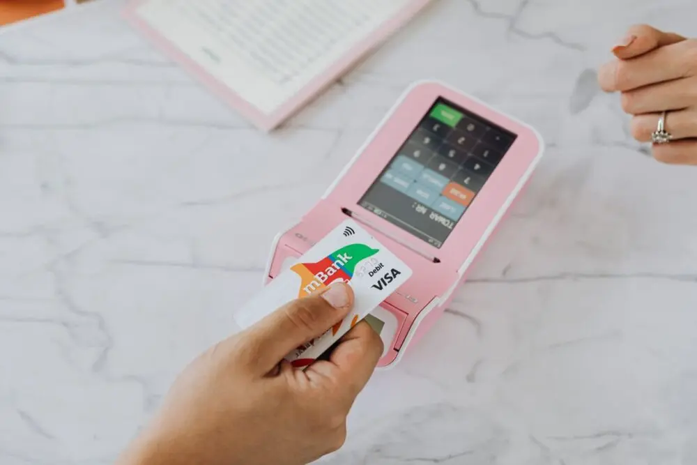 Contactless card payment on a pink payment terminal