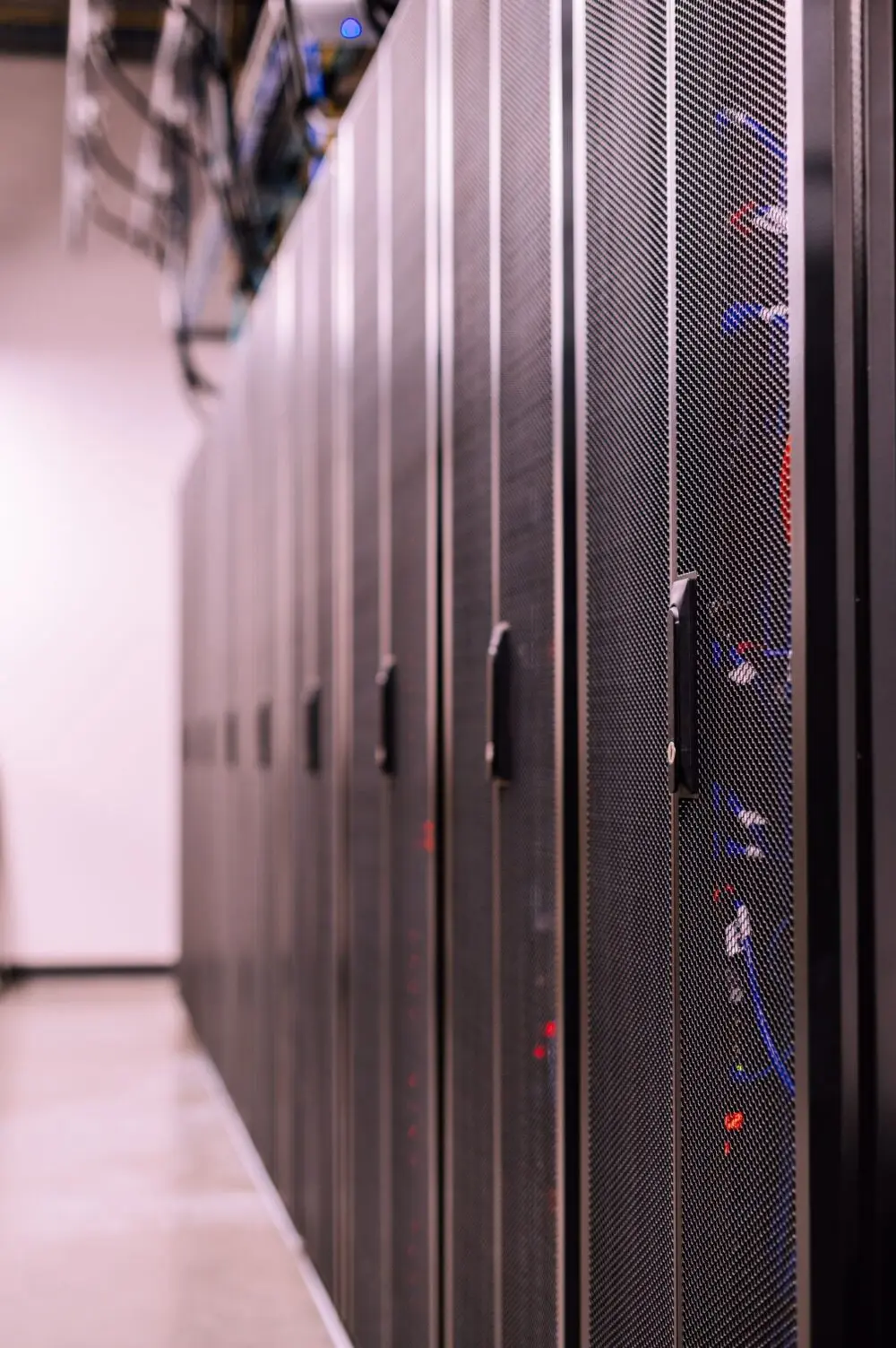 Server room with fiber optic cables and rack cabinets
