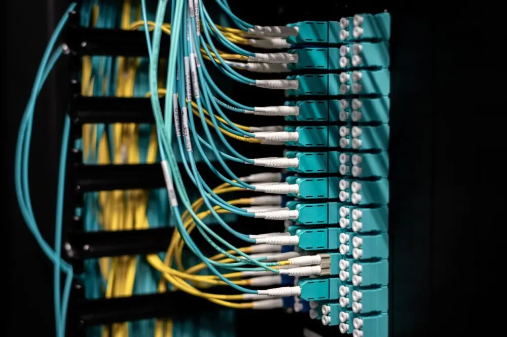 Network cables plugged into a server rack, equipment that capex covers in the Meta earnings report