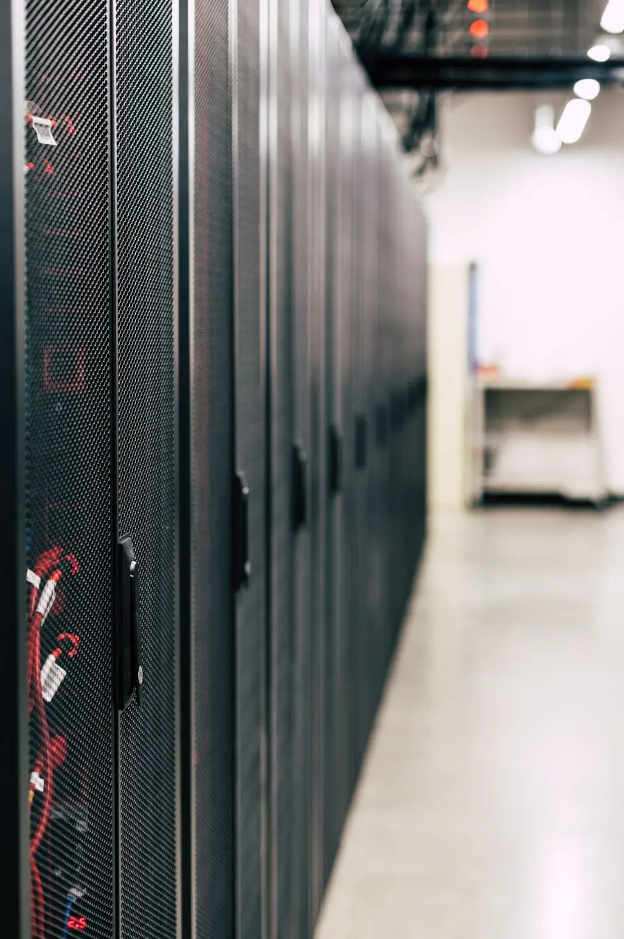 Rows of black server cabinets in a data center aisle