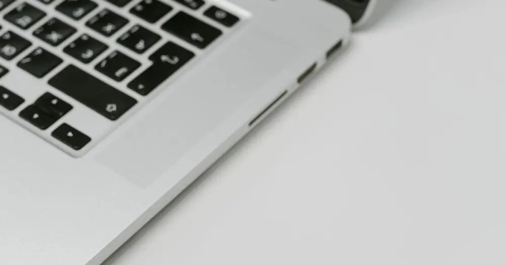A USB device standing in for hardware security keys beside a laptop