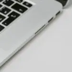 A USB device standing in for hardware security keys beside a laptop