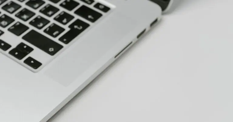 A USB device standing in for hardware security keys beside a laptop