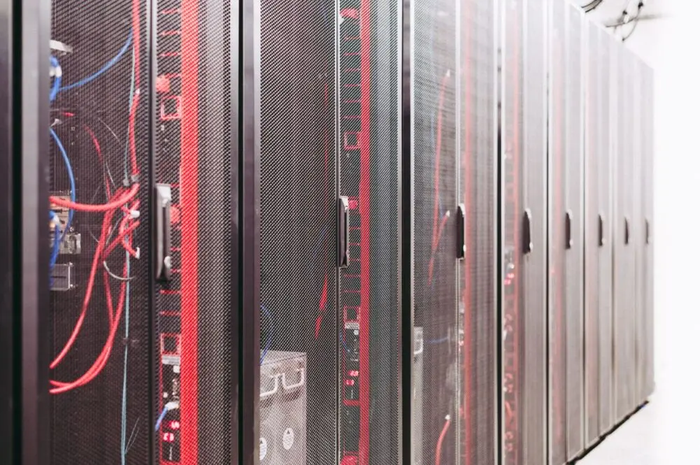 Server cabinets in a data hall like the Loughton site at the center of the Nscale Microsoft deal