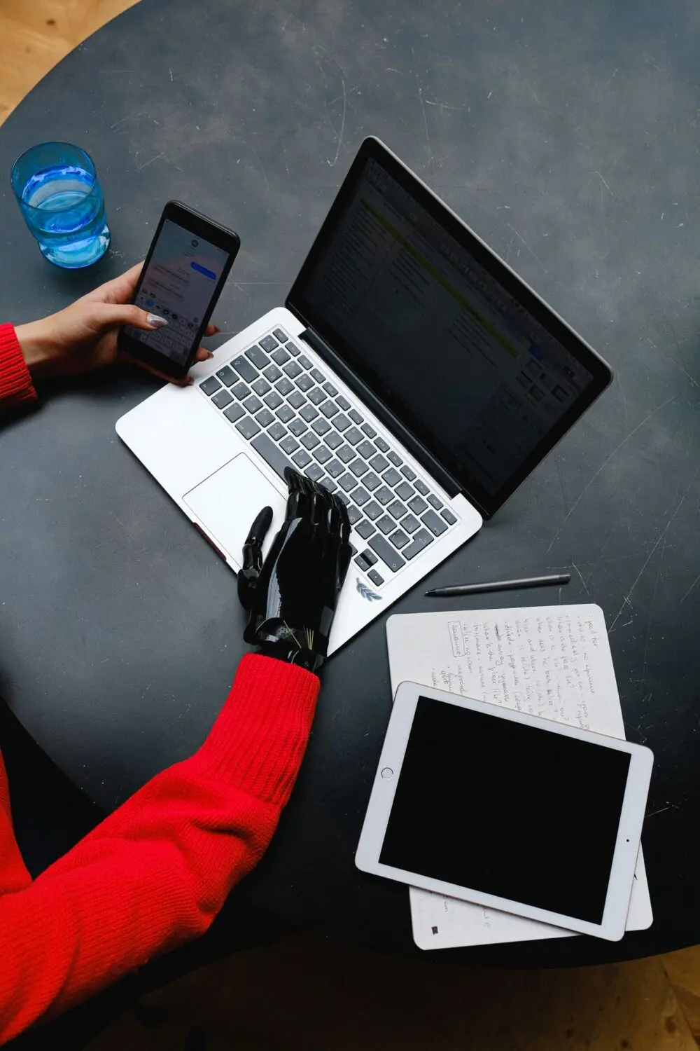 A robotic hand resting on a laptop keyboard, standing in for an AI agent working in an account