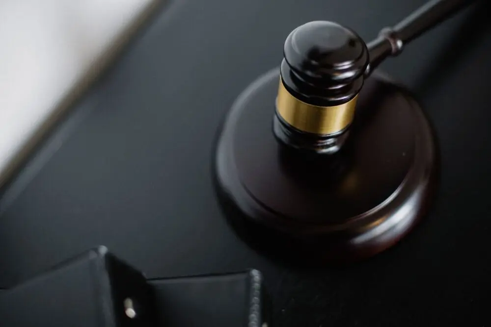 Wooden gavel on a round surface seen from above, representing the court cases in the OpenAI lawsuit