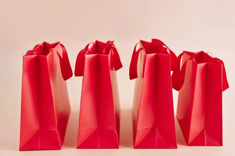 Row of red paper shopping bags, representing the holiday sales forecast for retailers