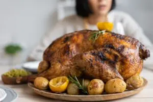 A roasted turkey on a wooden tray, the goal of getting turkey thawing times right