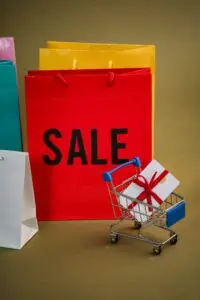 Colorful shopping bags and a mini cart with a gift, illustrating Black Friday 2026